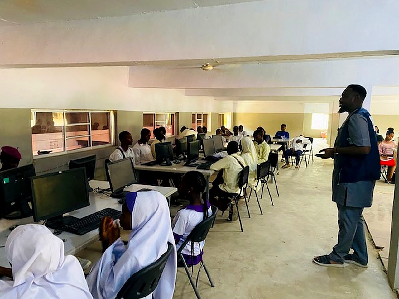 TADSEF facilitator leading a computer training session for public secondary school students
